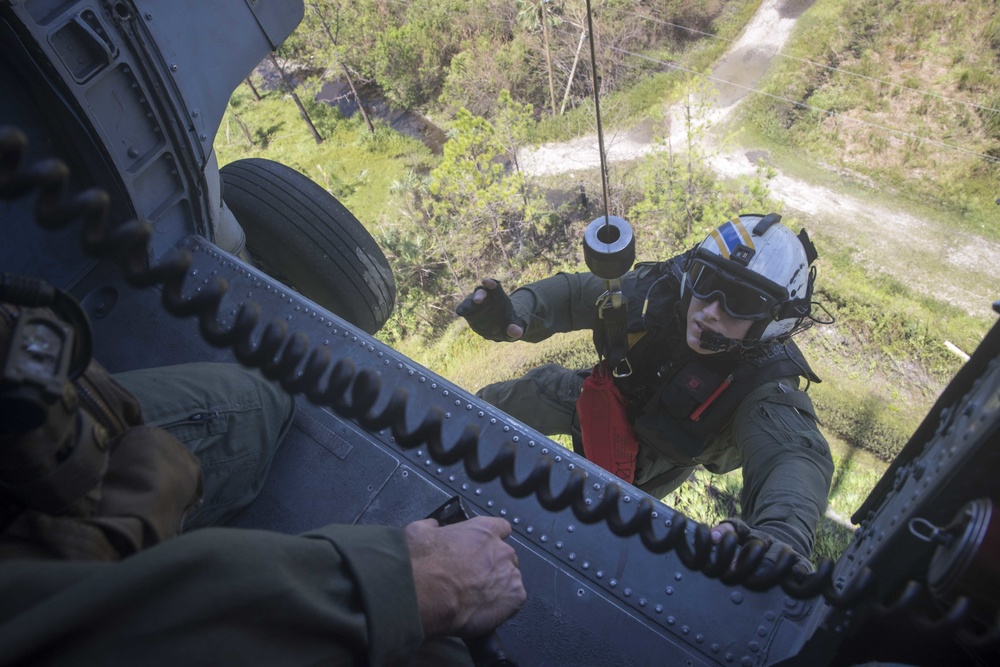 Air Crewman (Helicopter) 2nd Class Kurt Weber, from Langing, Kansas, is hoisted into an MH-60R Sea Hawk, from the Spartans of Helicopter Sea Maritime Squadron (HSM) 70,