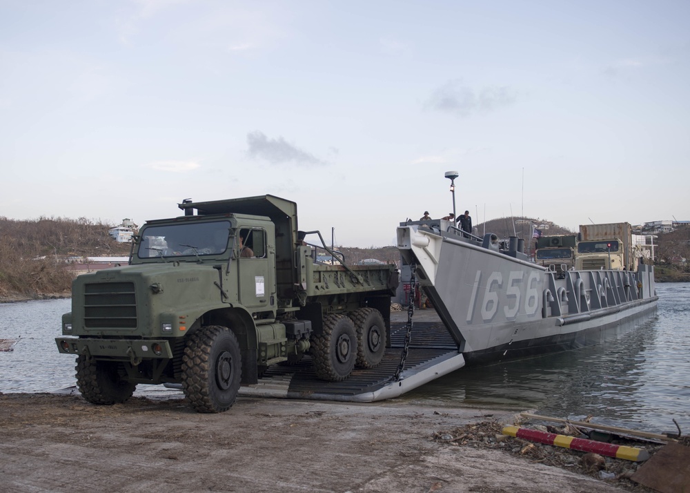 ehicles are offloaded from a landing craft utility (LCU), assigned to the dock landing ship USS Oak Hill (LSD 51)