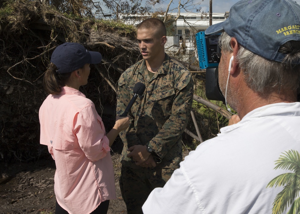 Lance Cpl. John Mark Johnson, from Wilmington, N.C., assigned to the 26th Marine Expeditionary Unit, answers questions for ABC News during a tour of Naval Air Station Key West and the local area