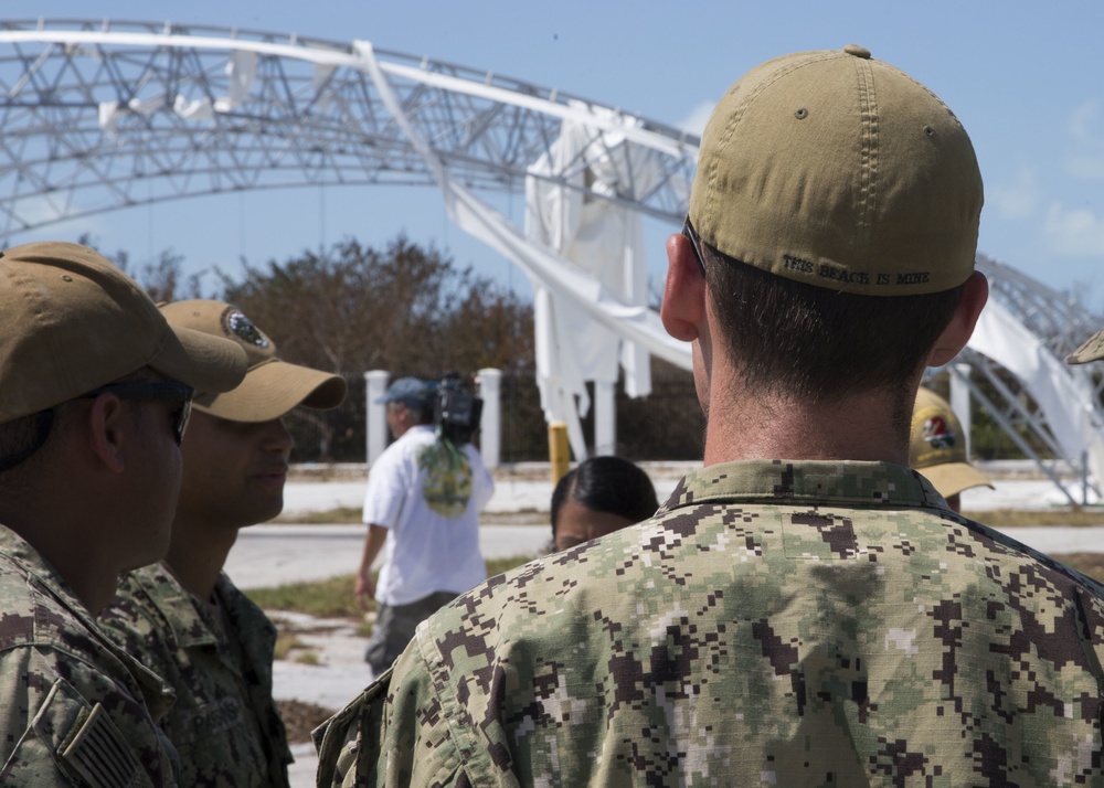 Sailors assigned to Beach Master Unit (BMU) 2 huddle to discuss debris removal caused by Hurricane Irma at Naval Air Station Key West's Port Operations