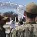 Sailors assigned to Beach Master Unit (BMU) 2 huddle to discuss debris removal caused by Hurricane Irma at Naval Air Station Key West's Port Operations
