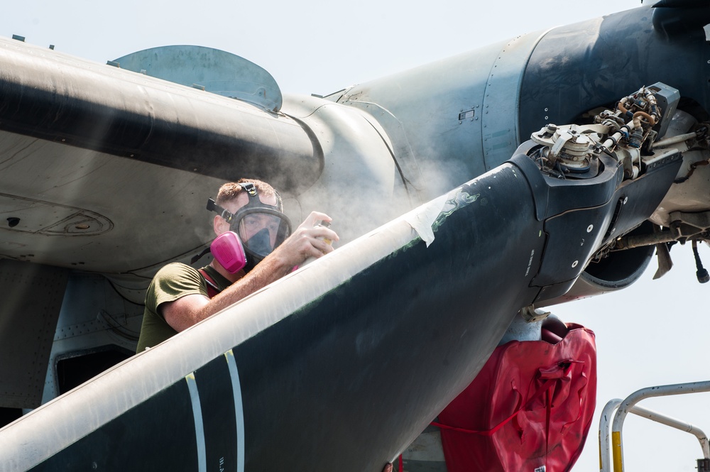 Marine conducts maintenance on MV-22 Osprey