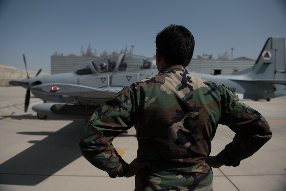 Afghan Airmen load munitions onto A-29 Super Tucano