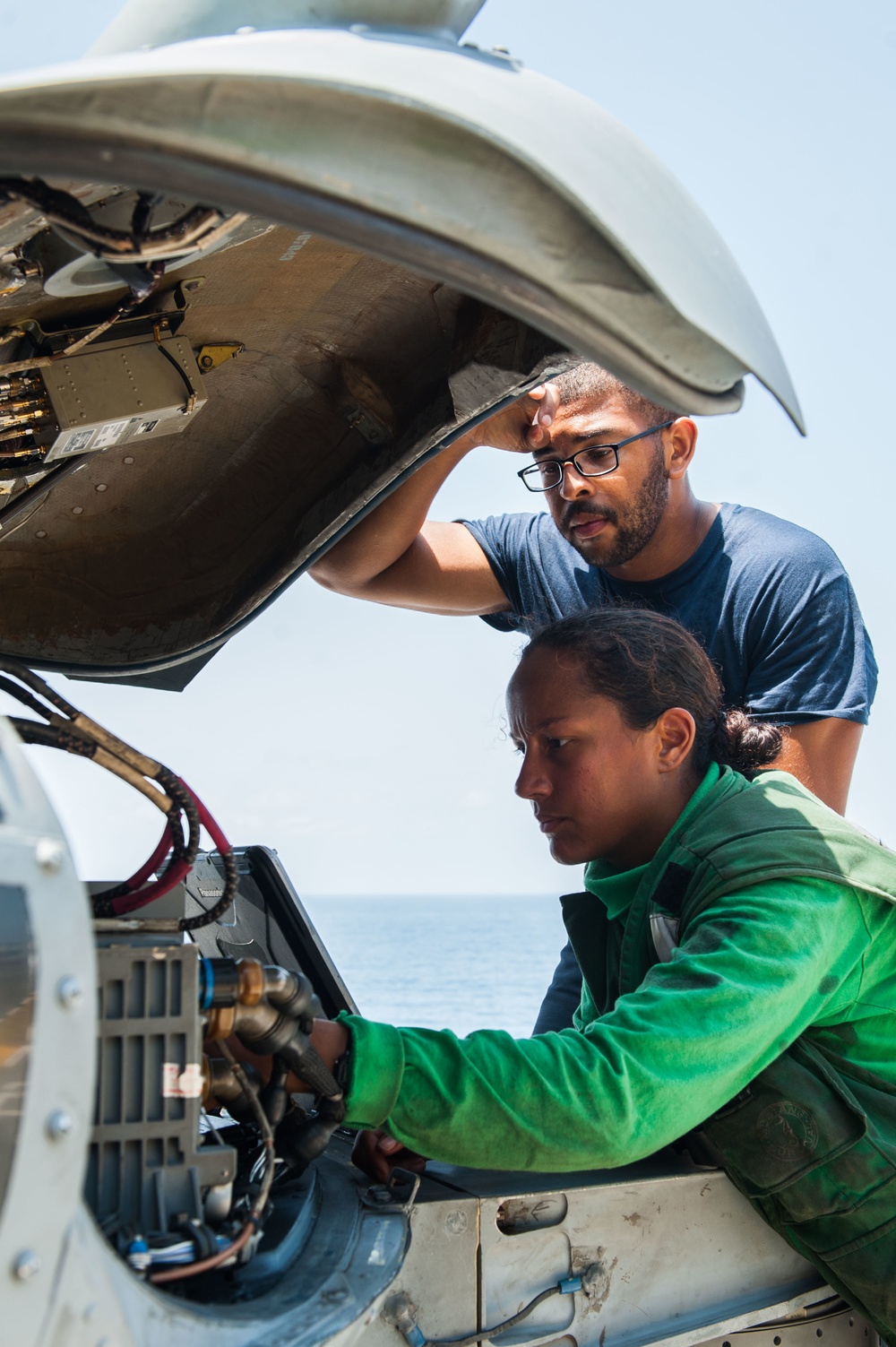 USS America Sailor conducts maintenance on Aircraft