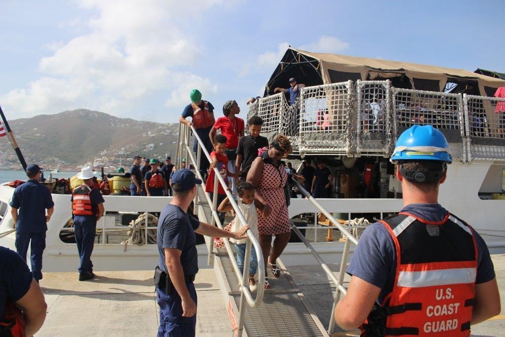 Coast Guard cutter Valiant crew members assist St. John evacuees as they prepare to leave the U.S. Virgin Islands