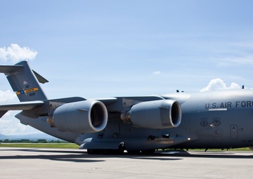Service members with JTF-LI prepare a C-17 for departure in support of HADR.