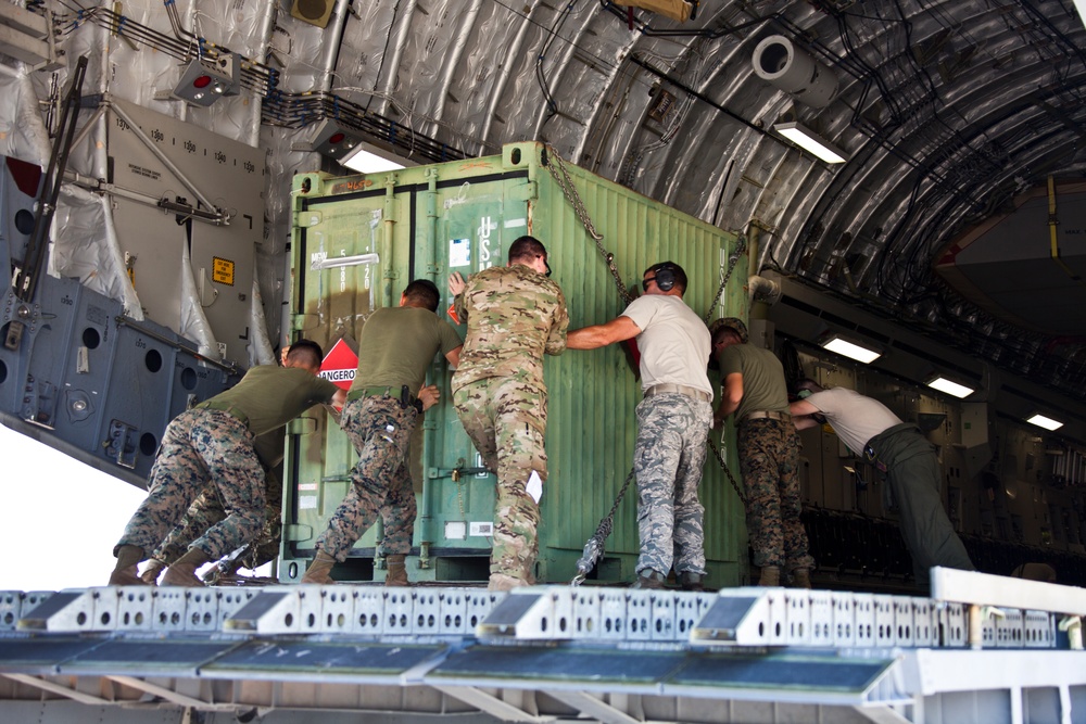 Service members with JTF-LI prepare a C-17 for departure in support of HADR.