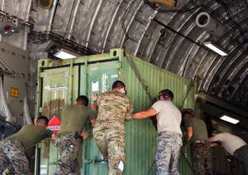 Service members with JTF-LI prepare a C-17 for departure in support of HADR.