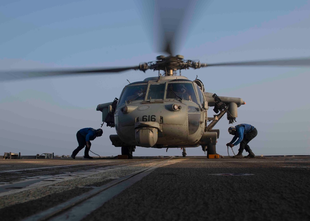 USS Lake Erie (CG 70) Sailors remove chalks and chains from MH-60S