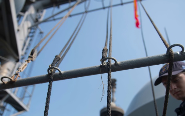 USS Lake Erie (CG 70) Sailor stands watch in pilot house