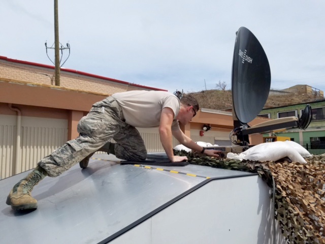Senior Airman Jade Brown, 269th Combat Communications Squadron, Ohio Air National Guard, adjusts the configuration of a satellite dish in St. Thomas, U.S. Virgin Islands Sept. 15, 2017. Brown is part of a six-person team providing tactical communications