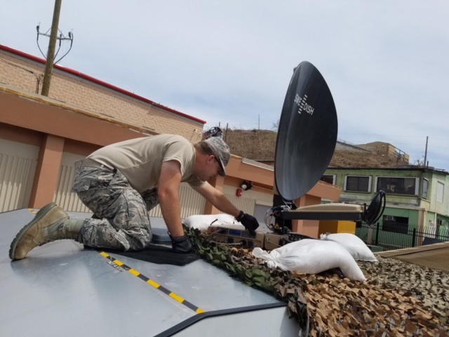 Tech. Sgt. Michael Miller, 269th Combat Communications Squadron, Ohio Air National Guard, adjusts the configuration of a satellite dish in St. Thomas, U.S. Virgin Islands Sept. 15, 2017. Brown is part of a six-person team providing tactical communications