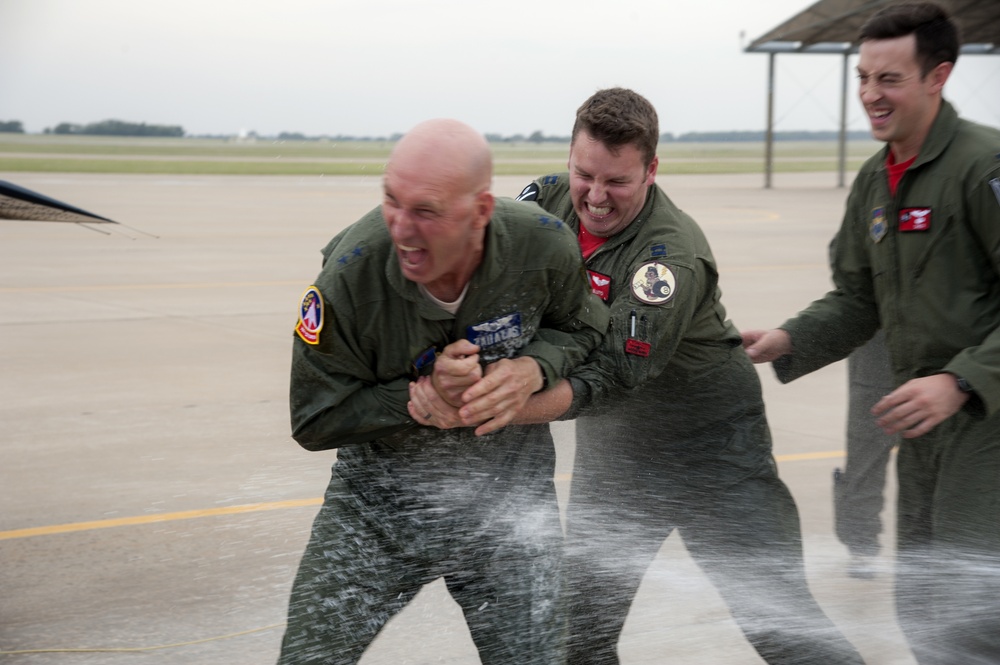 Maj. Gen. Zadalis  attempts to evade being sprayed with water following his “fini” flight