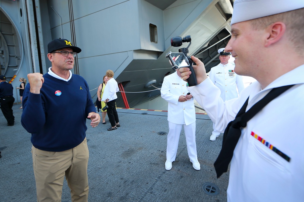 Jim Harbough, head football coach at University of Michigan, records a video message for the crew of USS Gerald R. Ford (CVN 78)