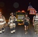 Firefighters and security forces participate in a 9/11 memorial walk