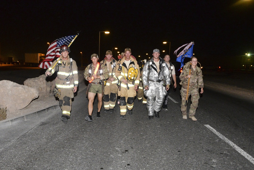 Firefighters and security forces participate in a 9/11 memorial walk