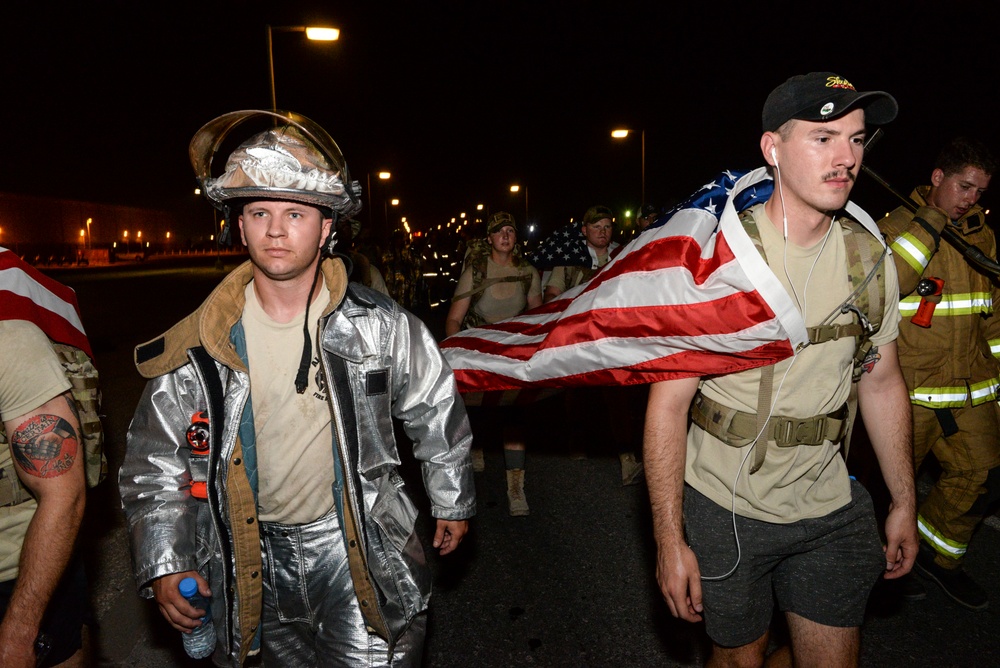 Firefighters and security forces participate in a 9/11 memorial walk