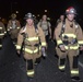 Firefighters and security forces participate in a 9/11 memorial walk