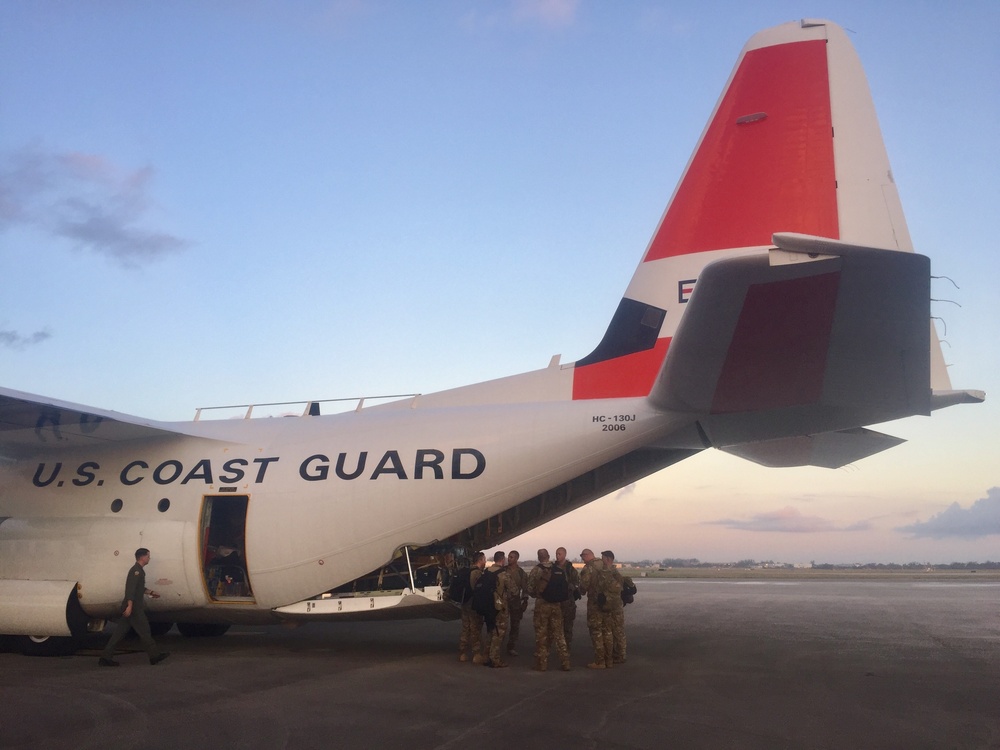 Coast Guard aircrews load supplies for Puerto Rico