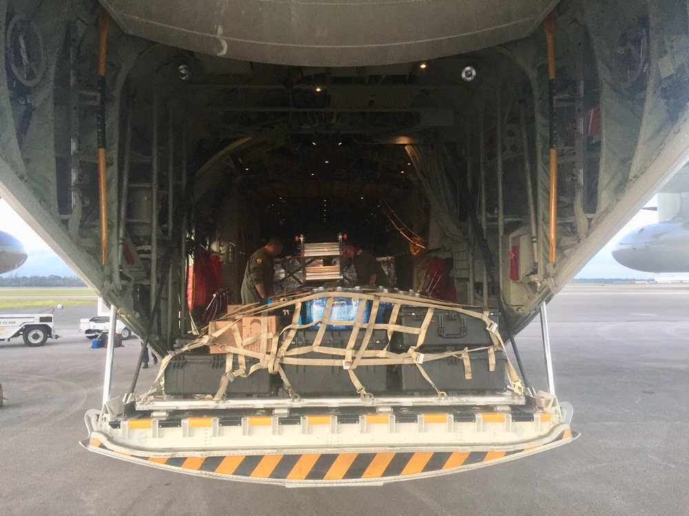 Coast Guard aircrews load relief supplies for Puerto Rico