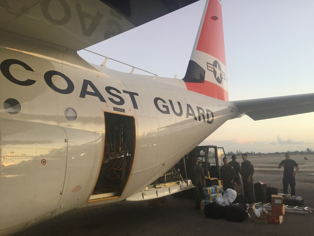 Coast Guard aircrews load relief supplies for Puerto Rico