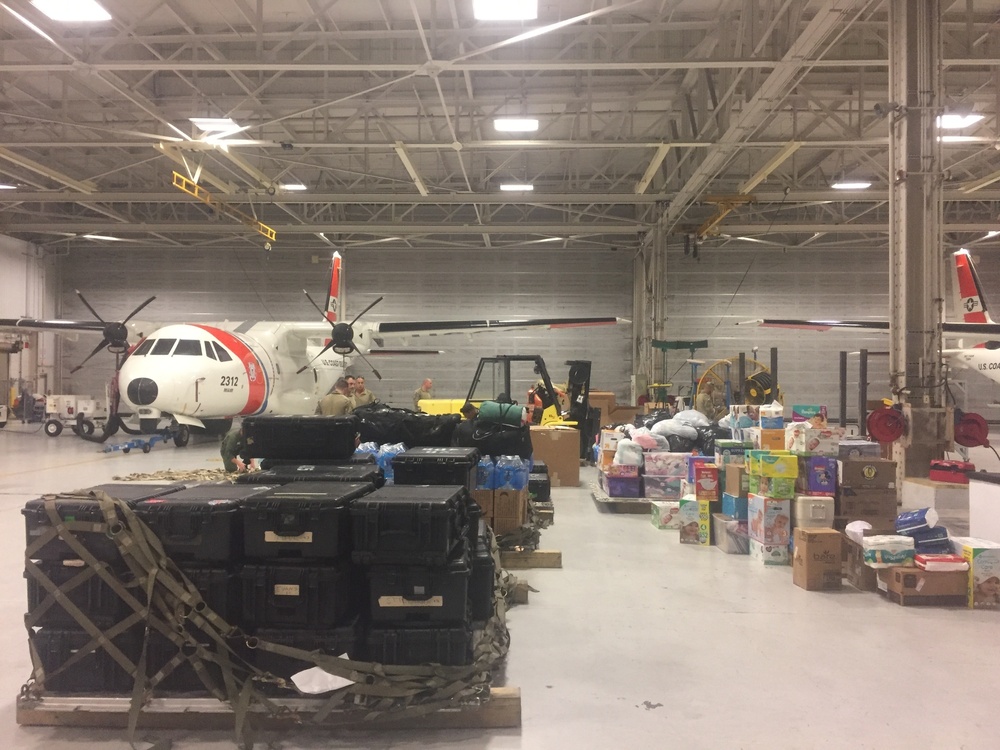 Coast Guard aircrews load relief supplies for Puerto Rico