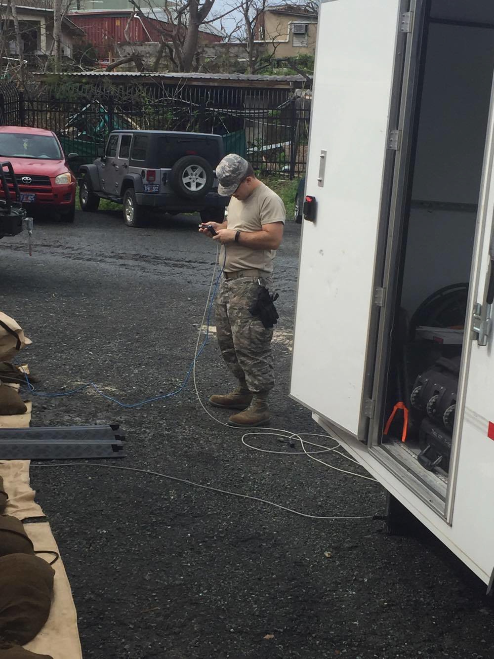 Tech. Sgt. Michael Miller, part of a six-member team from the 269th Combat Communications Squadron, Springfield Ohio Air National Guard Base, prepares satcom cables to restore communications for first responders in the aftermath of Hurricaine Maria in St.