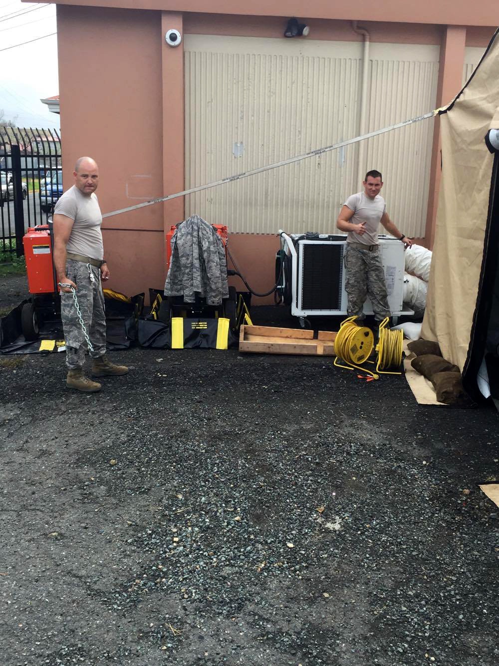 Tech.Sgt. Jason Clarkson and Master Sgt. Nathan Lukey, part of a six-member team from the 269th Combat Communications Squadron, Spriingfield, Ohio Air National Guard base,  prepares power and hvac for equipment to support first responders in the aftermath