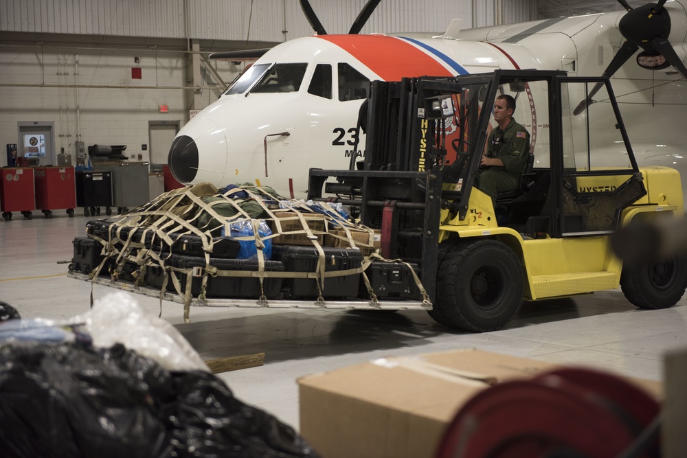 Coast Guard aircrews load relief supplies for Puerto Rico