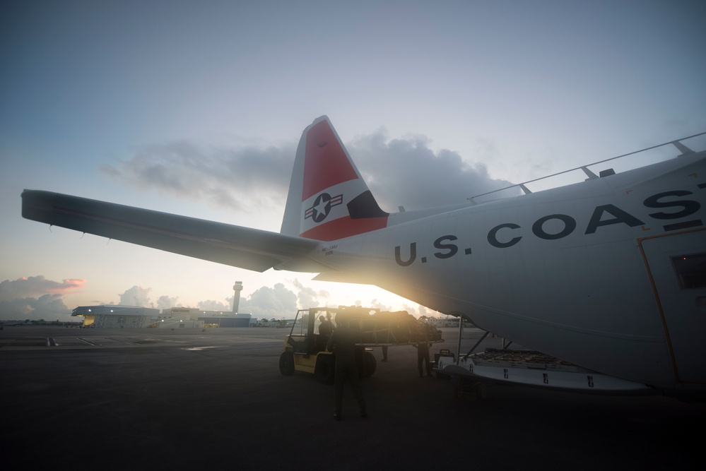 Coast Guard aircrews load relief supplies for Puerto Rico