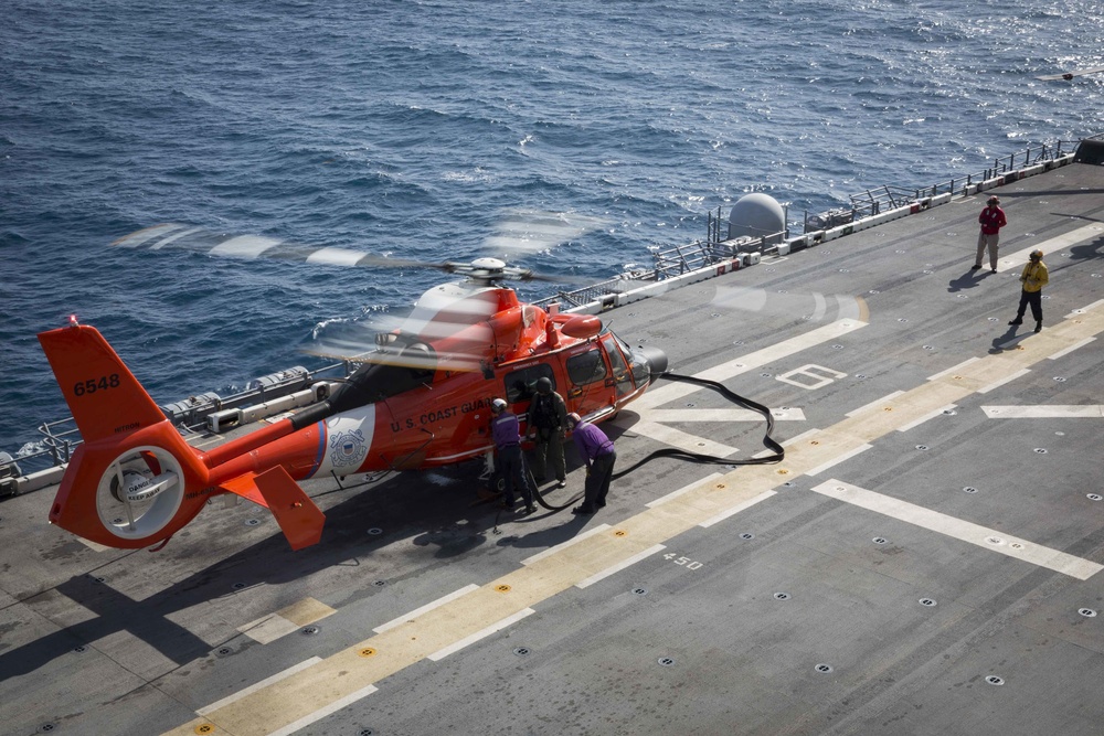 Coast Guard HITRON helicopter recieves fuel from U.S. Navy amphibious assault ship