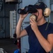 Sailor Speaks Through Sound Powered Phone on Nimitz