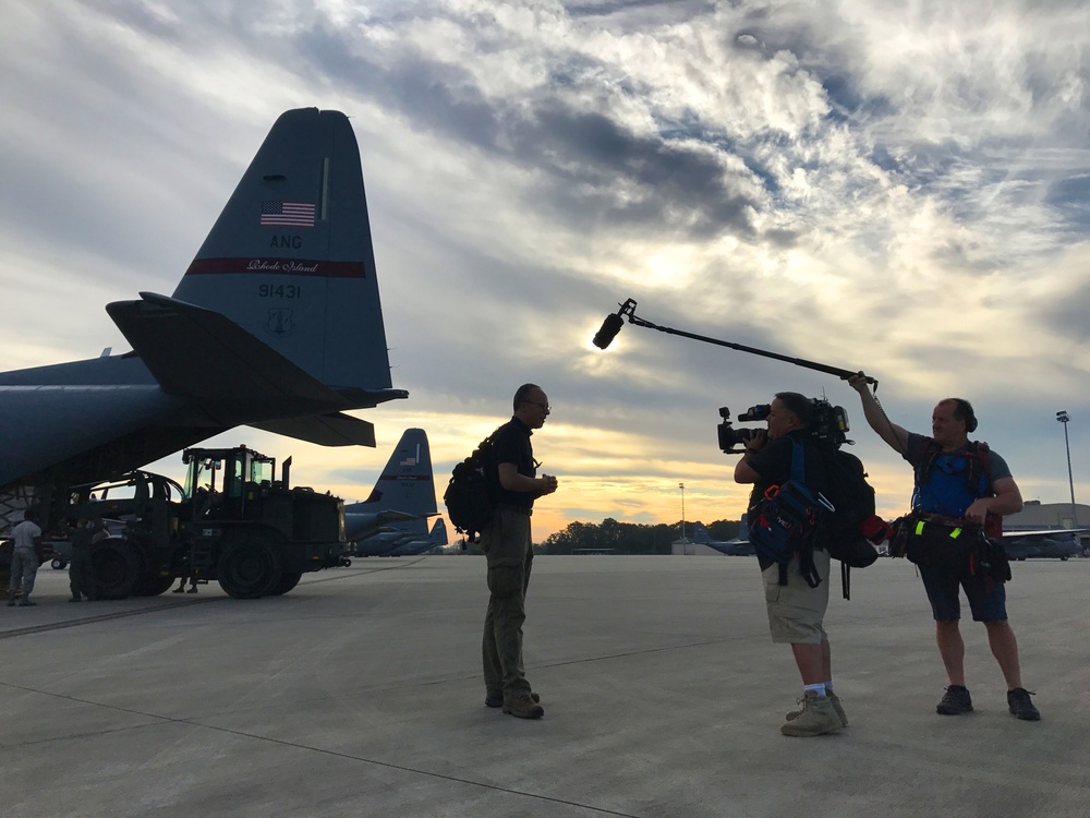 Lester Holt speaks on camera at the Savannah Air National Guard Base about the Hurricane Maria relief efforts