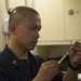 America Sailor prepares vaccinations for the crew