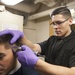 America Sailor cuts a Sailors hair