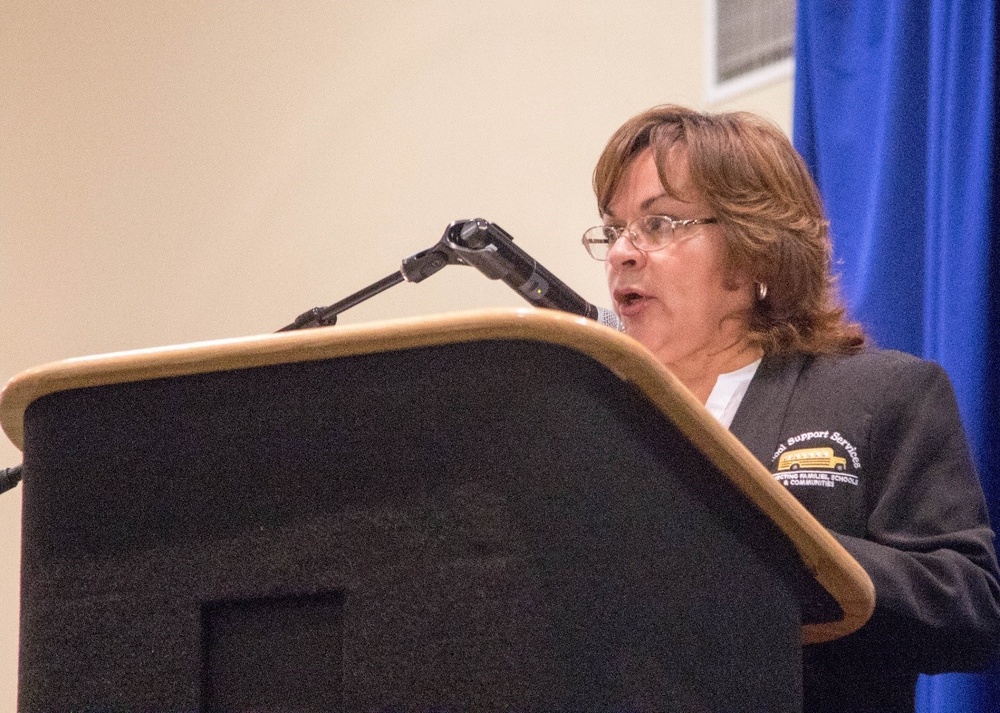 Patricia Lopez speaks to a combined group of the Partners in Education and military members in Fort Bliss