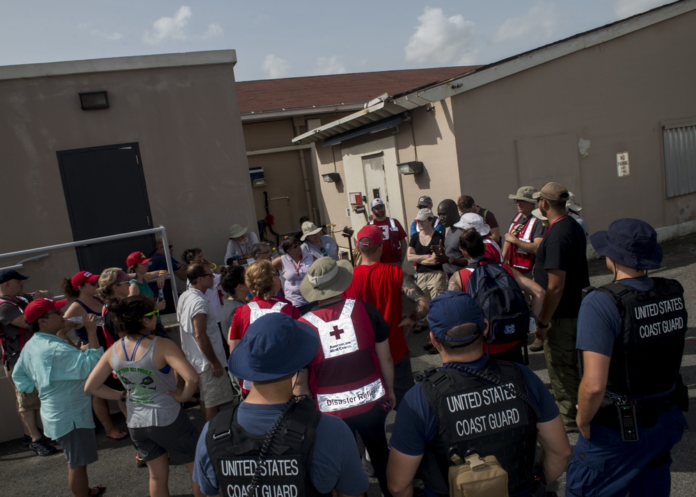 Coast Guard members from Marine Safety Unit Houston and Texas City, Texas, take part in a safety brief at Sector San Juan with volunteers from the American Red Cross