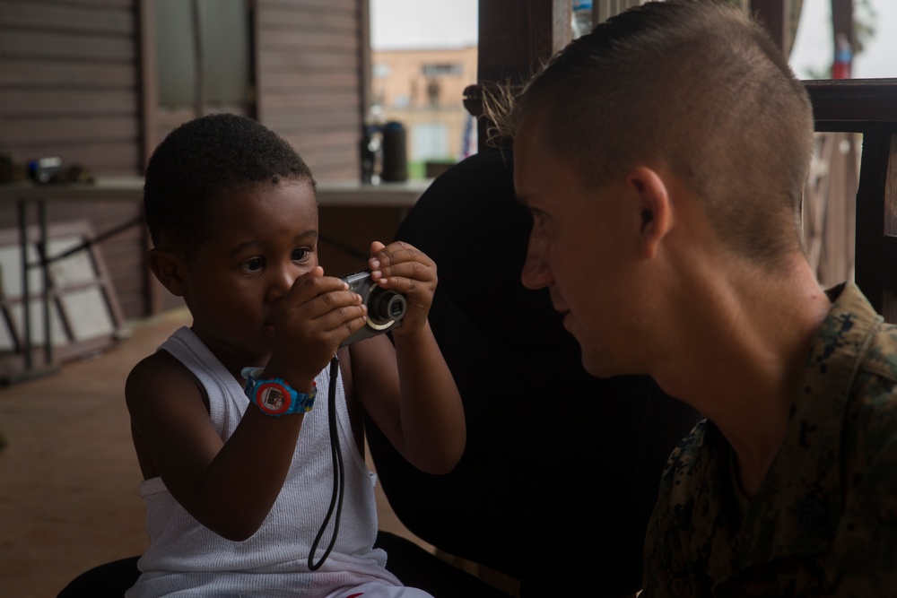 U.S. Marines help young evacuee on Dominica