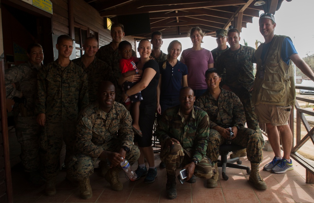 U.S. Marines help young evacuee on Dominica
