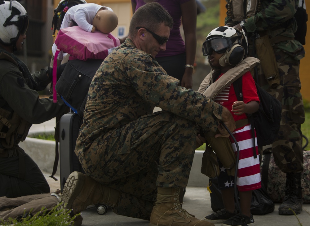 U.S. Marines help young evacuee on Dominica