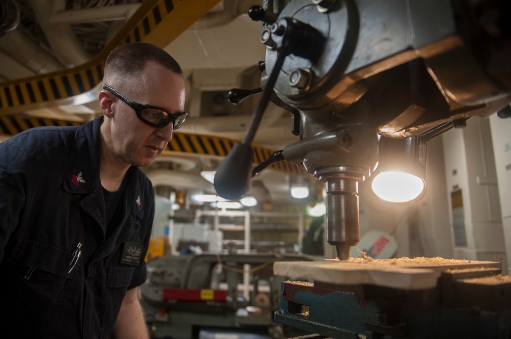 USS America Sailor creates walling plaque