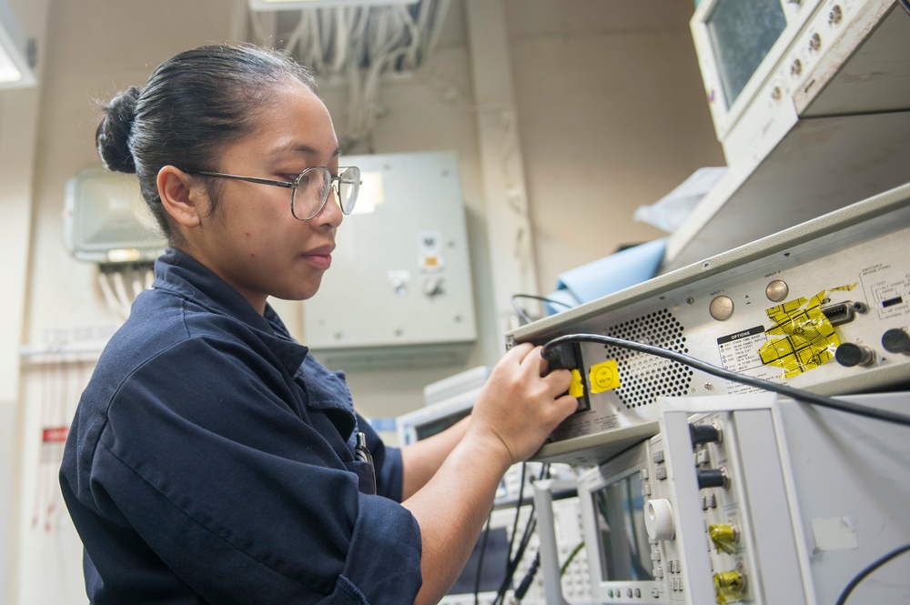 USS America Sailor prepares signal generator