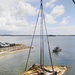 Response crews facilitate the hoist of a sailboat displaced by Hurricane Irma
