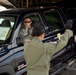 Tech. Sgt. Erika Rogers, 179th Airlift Group Mansfield, Ohio guides Senior Airman Timoth McCarty, 269th Combat Communications Squadron, Springfield Air National Guard Base, Ohio as he backs a vehicle onto a C-130 Hercules at Wright-Patterson Air Force Bas