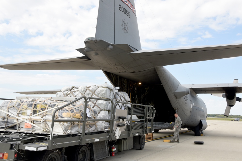 Equipment being loaded on a C-130 Hercules, from the 179th Airlift Wing, Mansfield, Ohio for a seven-person team from the 269th Combat Communications Squadron, Springfield Ohio Air National Guard Base as the 269th CBCS prepares to depart for St. Thomas, U