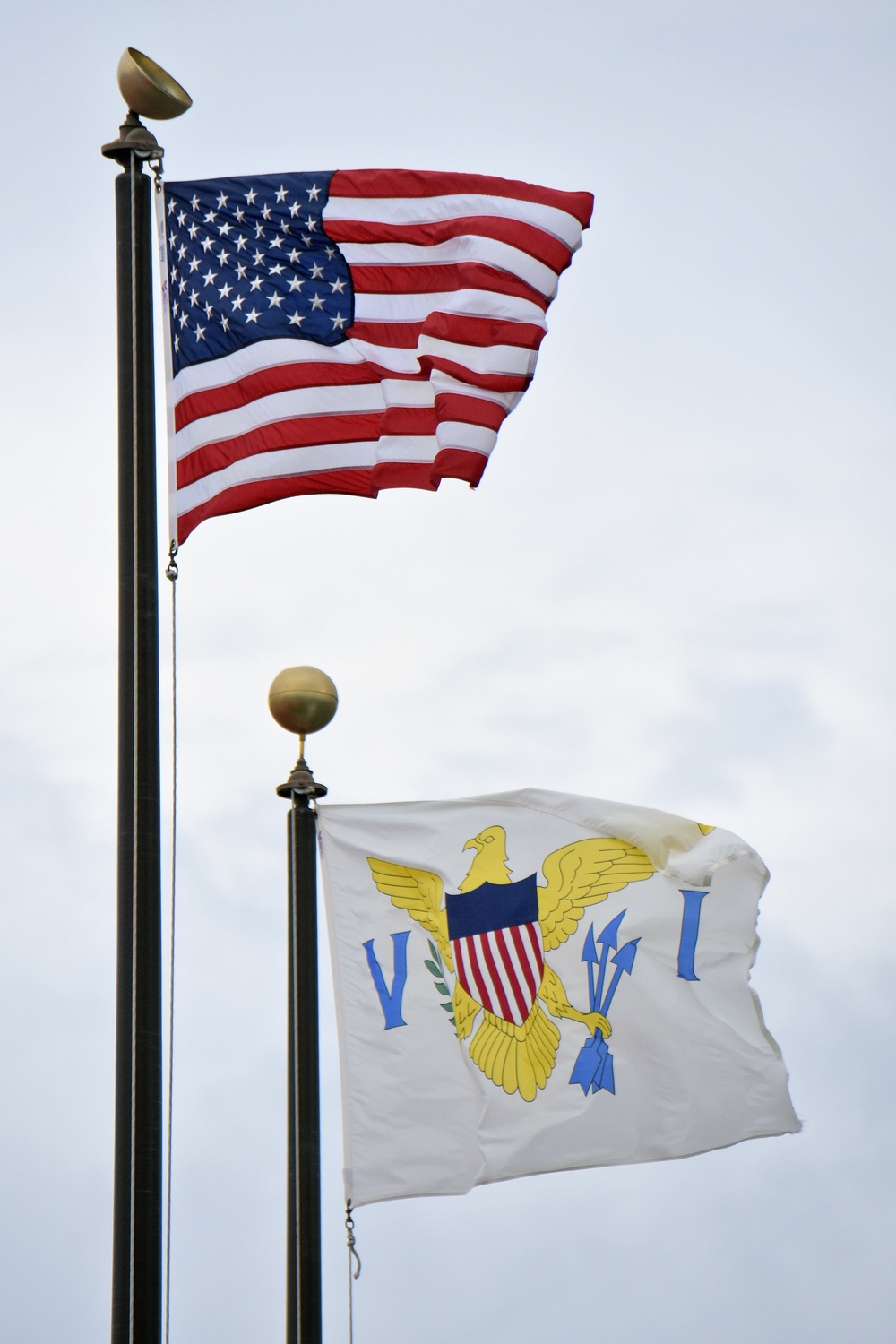 US and Virgin Islands flags wave in the winds of Hurricane Maria