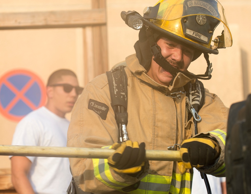 Firefighters with the U.S. Air Force and Qatar Emiri Air Force complete a firefighter combat challenge at Al Udeid Air Base