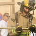 Firefighters with the U.S. Air Force and Qatar Emiri Air Force complete a firefighter combat challenge at Al Udeid Air Base