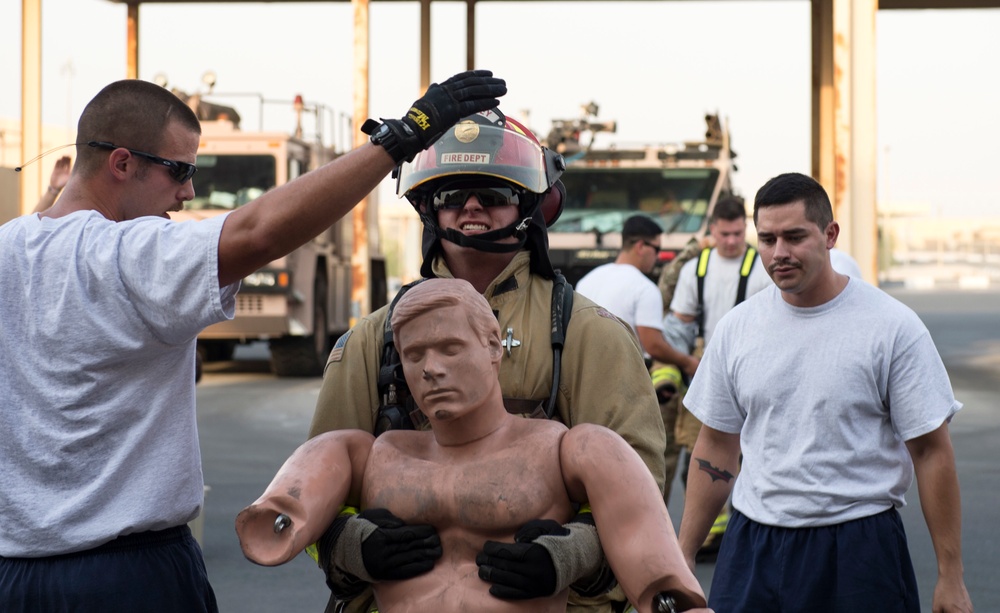 Firefighters with the U.S. Air Force and Qatar Emiri Air Force complete a firefighter combat challenge at Al Udeid Air Base