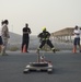 Firefighters with the U.S. Air Force and Qatar Emiri Air Force complete a firefighter combat challenge at Al Udeid Air Base